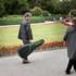 Italian guitarist and street musician Fausto Cassara laughs and talks to a passer-by in the Hofgarten.