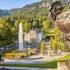 The park of Linderhof Palace with fountains and statues in the sunshine.