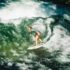 Female surfer catching a wave on the Eisbach in Munich