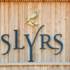 The logo of the Slyrs distillery on a wooden house