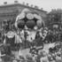 A carnival parade with the carnival float “Die Schirmgilde“ at Odeonsplatz in Munich in 1900.