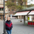 A young woman stands in the middle of the empty Viktualienmarkt in Munich.