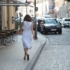 Back view of a woman in a dress walking along Feilitzschstrasse in Munich-Schwabing.