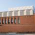 The modern tree of the Volkstheater in Munich is enclosed by a brick building