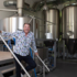 A man stands in a brewery in Munich and smiles.