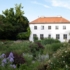 White house in the middle of a flower garden in Munich