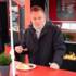 Michelin-starred chef Stefan Barnhusen eats a curry sausage at Schneds Gourmet Grill