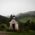 A chapel framed by green mountains in the fog in the Munich environs.