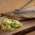 A portion of fish with potato salad, nicely arranged on a wooden board.