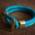 A blue bracelet by Enzo Escoba lies on a brown background.