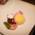 A dessert of vanilla ice cream, chocolate brownie and currants is served on a white plate in GOP Varieté-Theater in Munich.