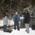 Three men standing together in the snow