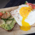 Bread with avocado and fried egg on a wooden board in Munich