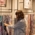 A woman looks at scarves in a shop