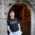 Florian Falterer, owner of Café Crönlein in Munich, stands in front of his restaurant wearing a black T-shirt with the word "Giesing" on it.