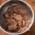 A bowl of gingerbread dough stands on a table.