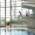 A woman in a swimming costume jumps from the 3-metre board in the swimming hall