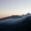 Sunset atmosphere in the mountains with wafts of mist moving over the peaks.