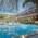 View into a covered indoor swimming pool with attached hotel and tropical atmosphere.