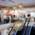 Interior view of the bookstore “Hugendubel“ in Munich with escalators, lamps and people in front of bookshelves