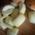 Sliced apple pieces lie next to a sultana bread on a wooden board