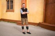 A man at the Oktoberfest who is wearing a traditional bavarian costume.