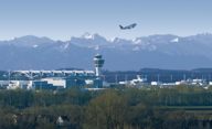 Ascending airplane in front of the alps.