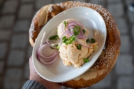 A plate of obazda on a big pretzel in Augustiner-Keller beer garden in Munich.