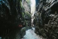 Group of people with torches in the Partnachklamm nearby Garmisch in the surrounding region of Munich.