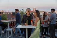 Several people standing in the outdoor area on a roof terrace in Munich.