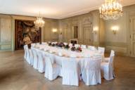 A festive hall with white table and chairs at the Hotel Bayerischer Hof