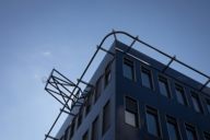 View from below of a corner of the Hochschule für Fernsehen und Film building in the Maxvorstadt district of Munich against a blue sky