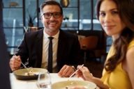 A woman and a man are eating in the restaurant Esszimmer at BMW Welt in Munich.