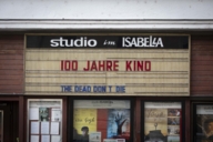 Cinema entrance of Studio Isabella in Munich with old showcases and old programme board.