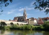 The cityscape of Regensburg with the cathedral in front of the Danube
