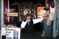 The smiling cashier of the Hexenschaukel (witch swing) at the Oktoberfest in Munich