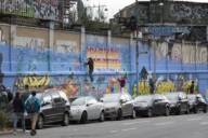 Graffiti artists paint a brick wall in the slaughterhouse district