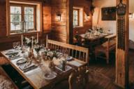 Wooden room in the alpine hut with covered tables