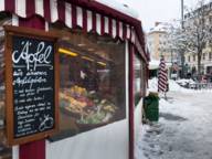 A fruit and vegetable stand at the Viktualienmarkt in Munich during the winter.