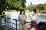 Two women eating ice cream at the Isar in Munich.