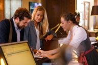 A man and a woman are checking in at a hotel in Munich.