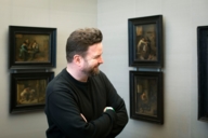 A man looking at paintings in the Alte Pinakothek in Munich