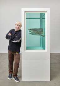 British sculptor and painter Damien Hirst at MUCA next to one of his exhibition works