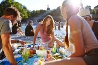 A group of young people at a picnic on the Isar river in Munich.