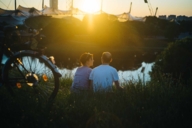 A couple is watching the sunset at the Olympiapark in Munich.