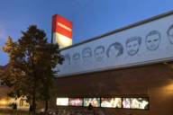 The façade of the Munich Volkstheater at nightfall