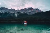 Two men in a rowing boat on Eibsee nearby Garmisch in the surrounding area of Munich.