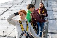 A woman is looking into the distance on the roof of the Olympic Stadium in Munich.