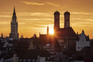 Sunset over Munich with the Frauenkirche and the New City Hall.