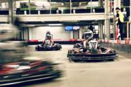 Several drivers are on the kart track at the Kart Palast in Munich.